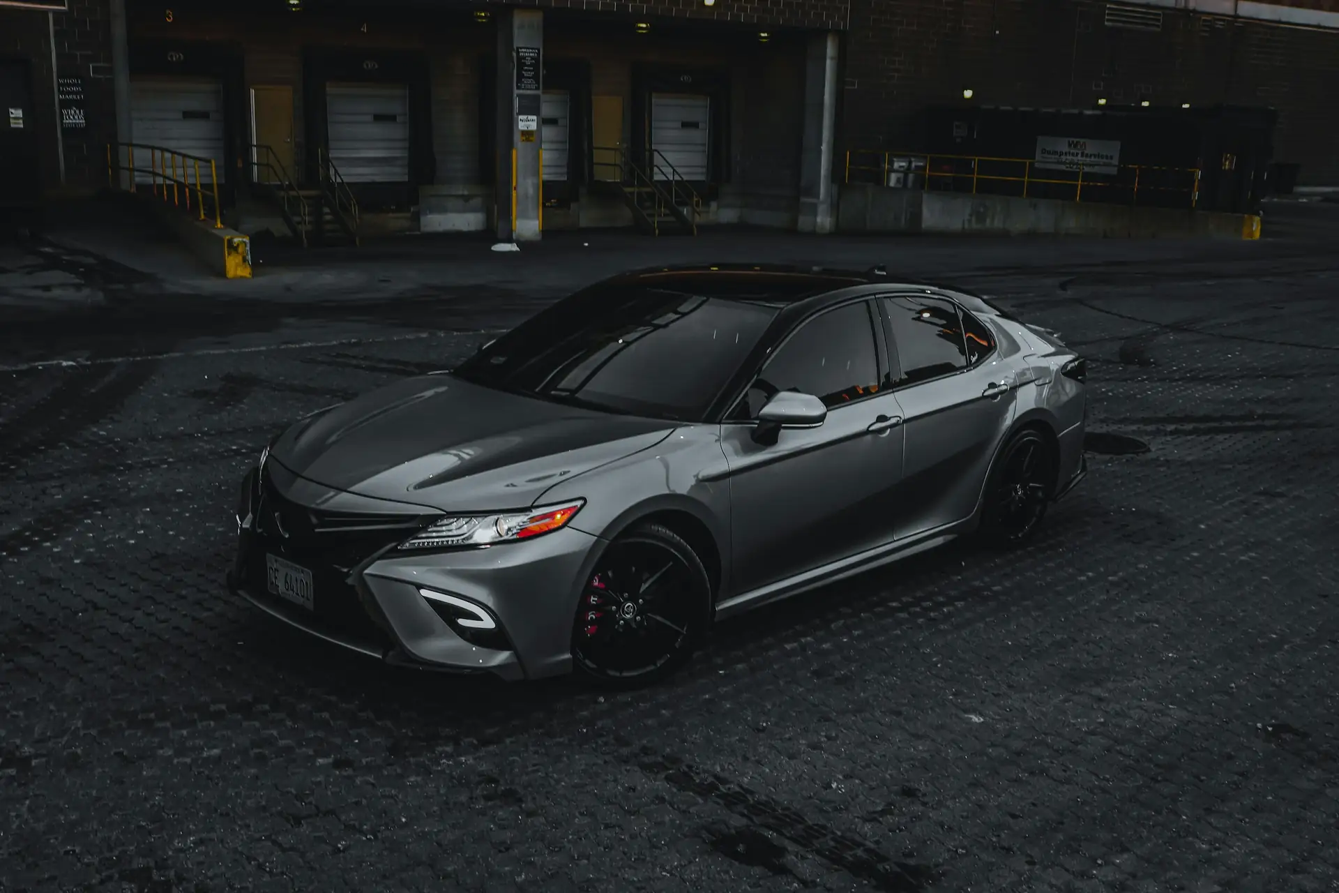 Grey Toyota Camry parked at dusk